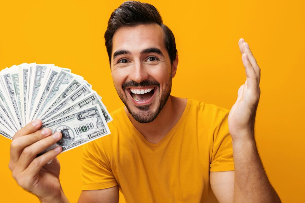Rich man business background yellow hand surprised cash finance currency dollar money happy smiling